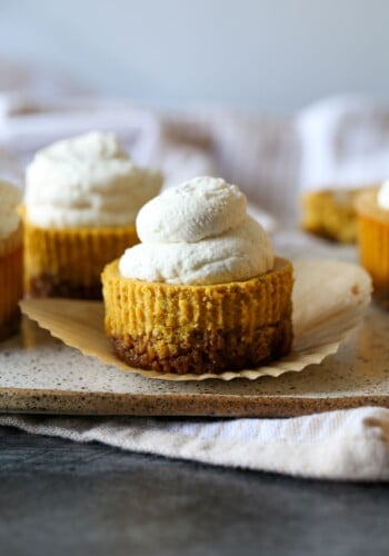 Mini Pumpkin Cheesecakes on a serving plate unwrapped