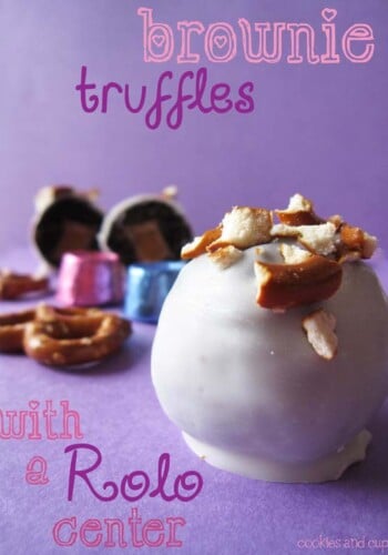 Close-up of a white chocolate dipped brownie truffle topped with pretzel pieces